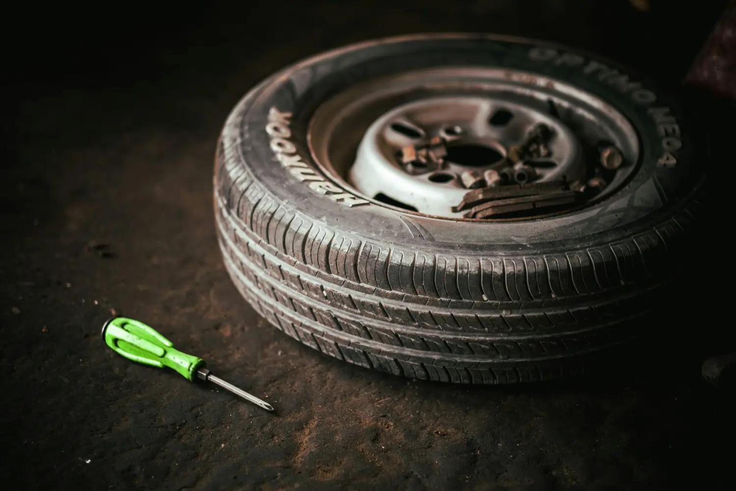 car tire and screwdriver